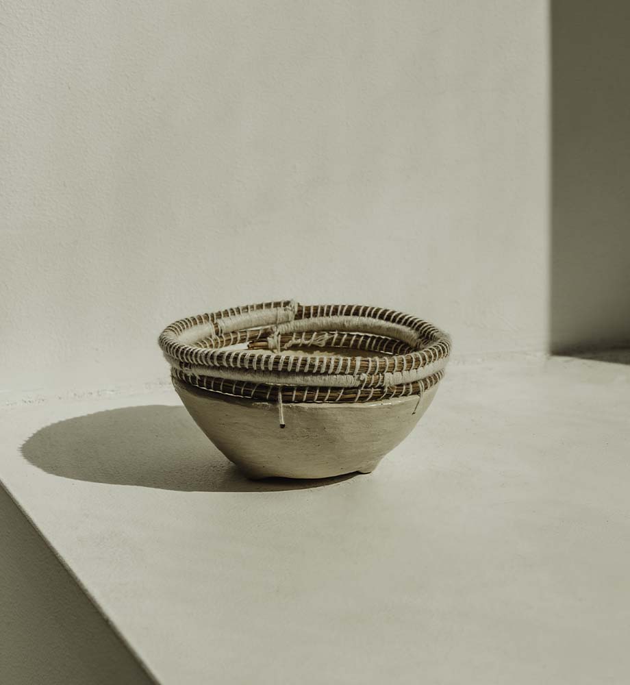 Tan clay bowl with shadows in the background