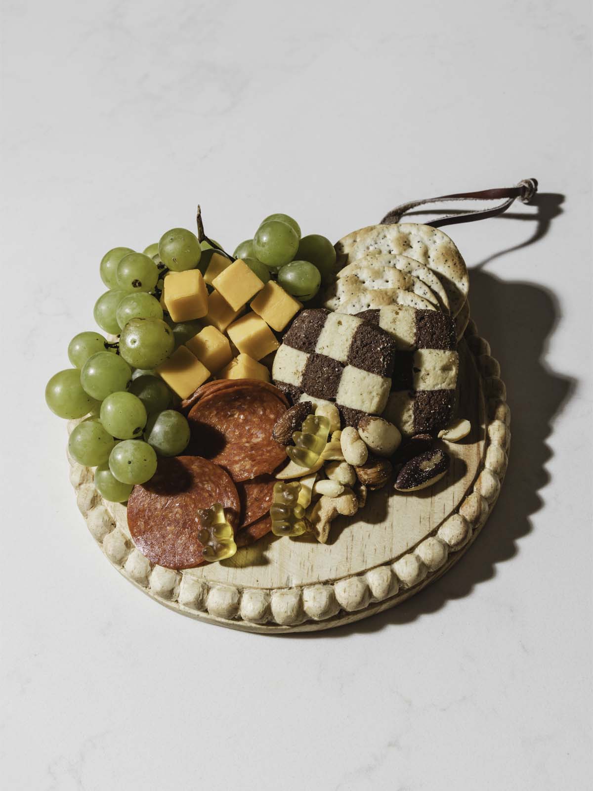 wooden round serving table with an assortment of foods on top