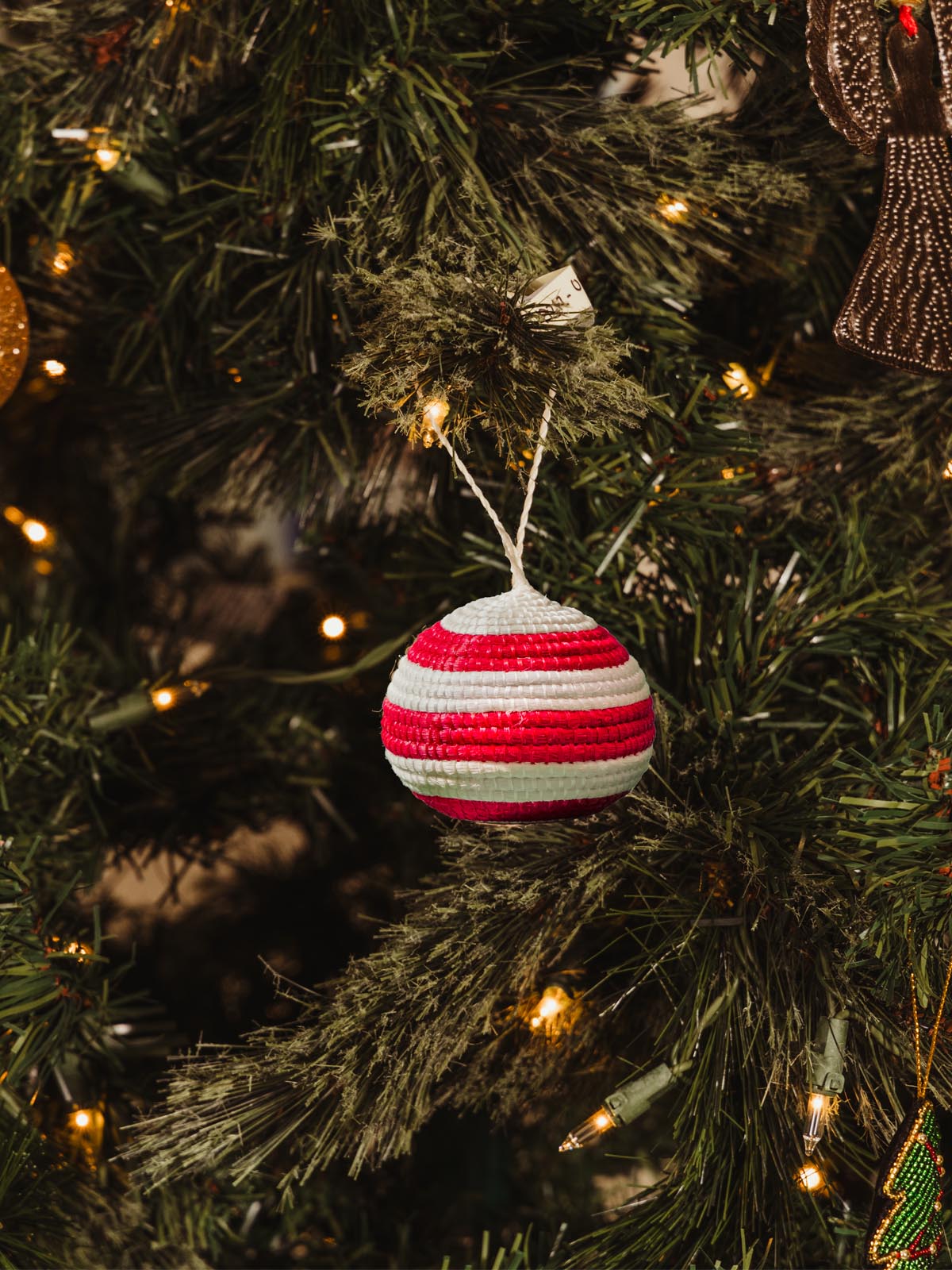 red striped ornament in a Christamas tree