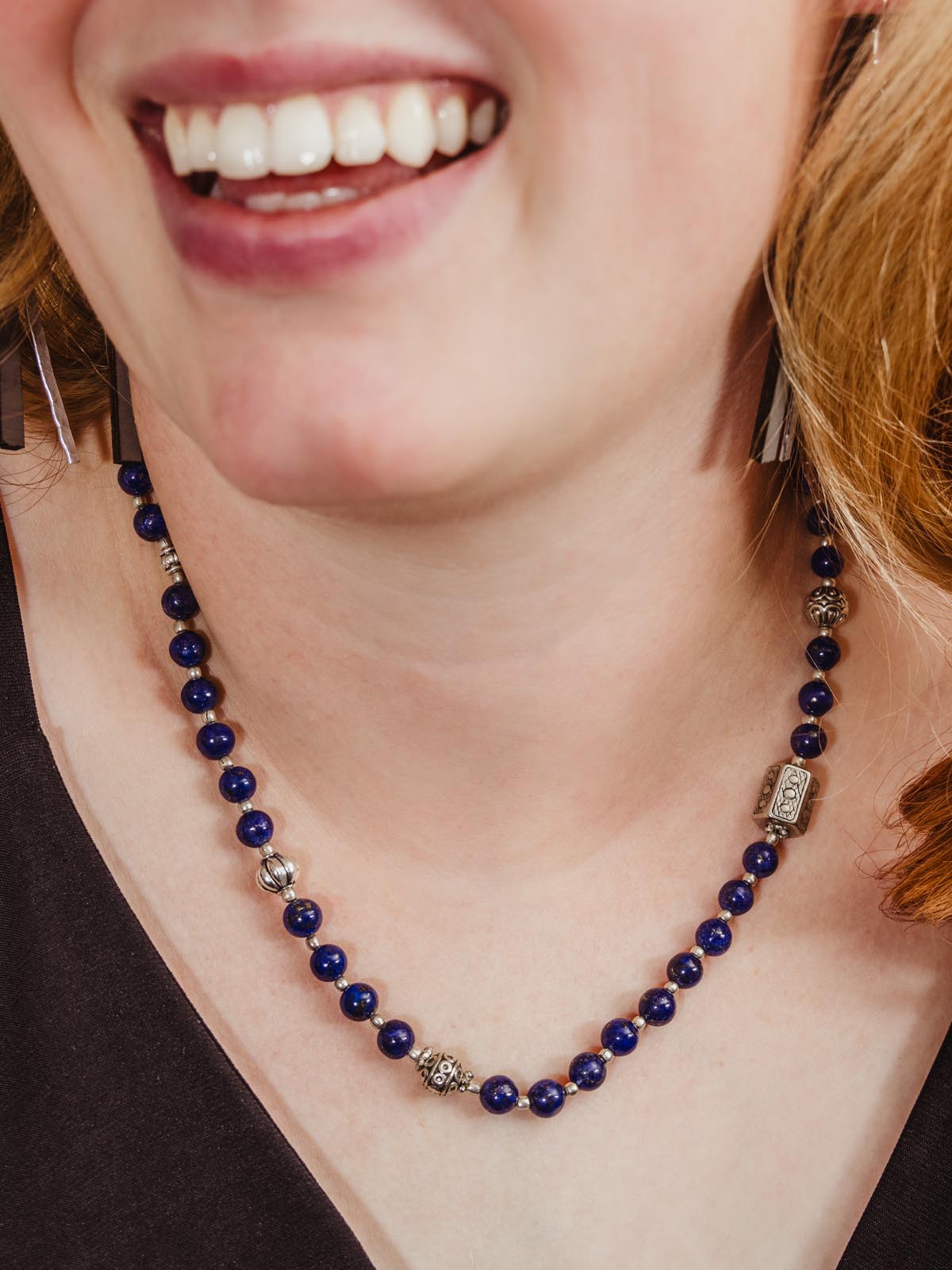 Female model wearing blue and silver beaded necklace