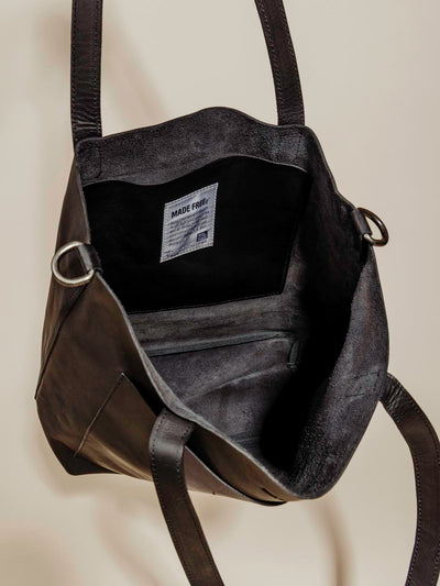 Interior photo of Made Free black leather bag on a neutral background.