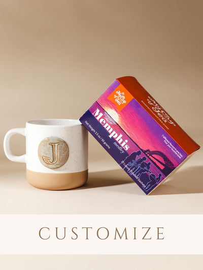 Box of memphis medley tea and mug on cream Background with customize sticker. 