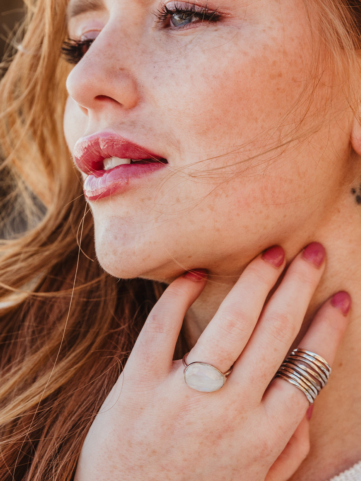 Female model wearing two rings featuring the white moonstone.