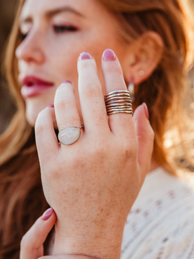 Close up of female models hand wearing white moonstone ring