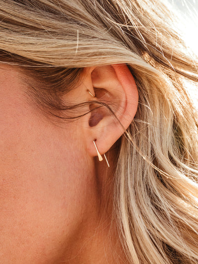 Close up of female model wearing gold Staple Threader Earring