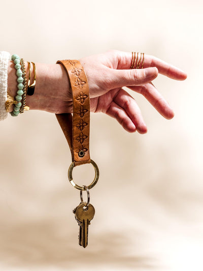 Hand Stamped Leather Keychain Wrestler on models hand with keys.