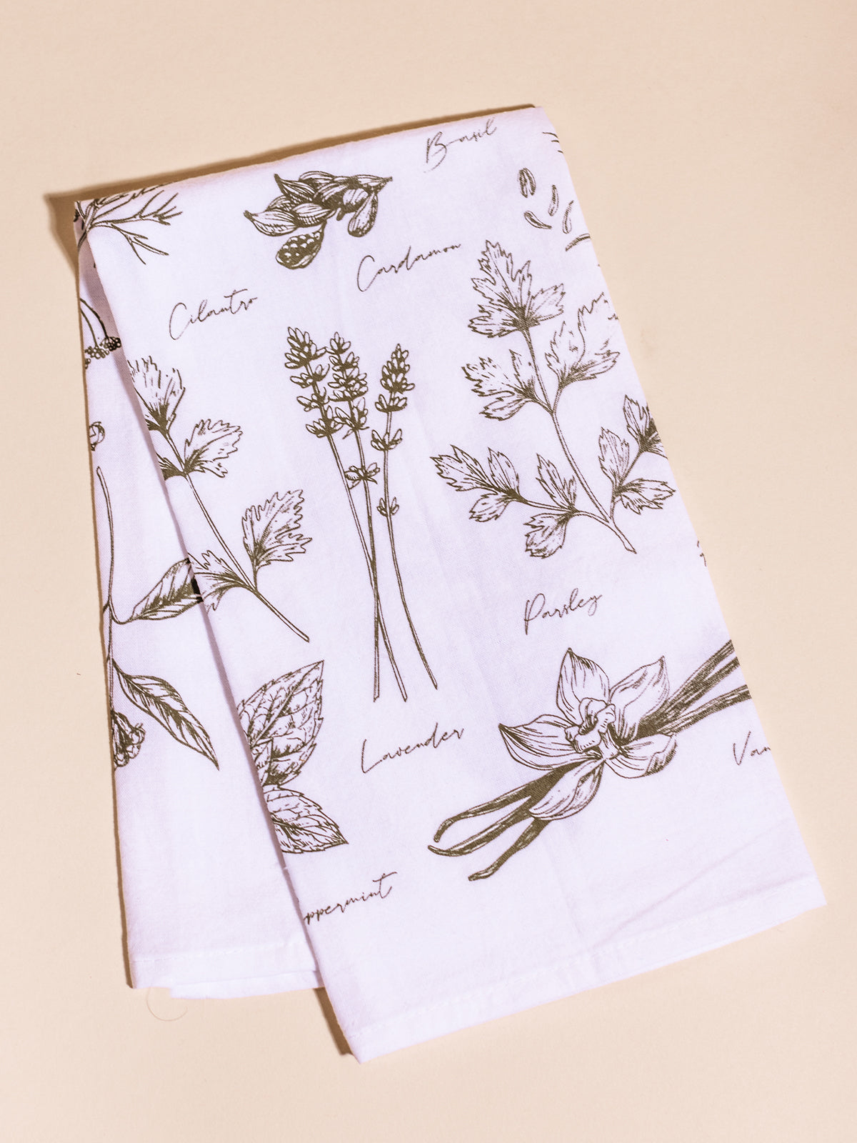 Herbs line art tea towel on a cream background