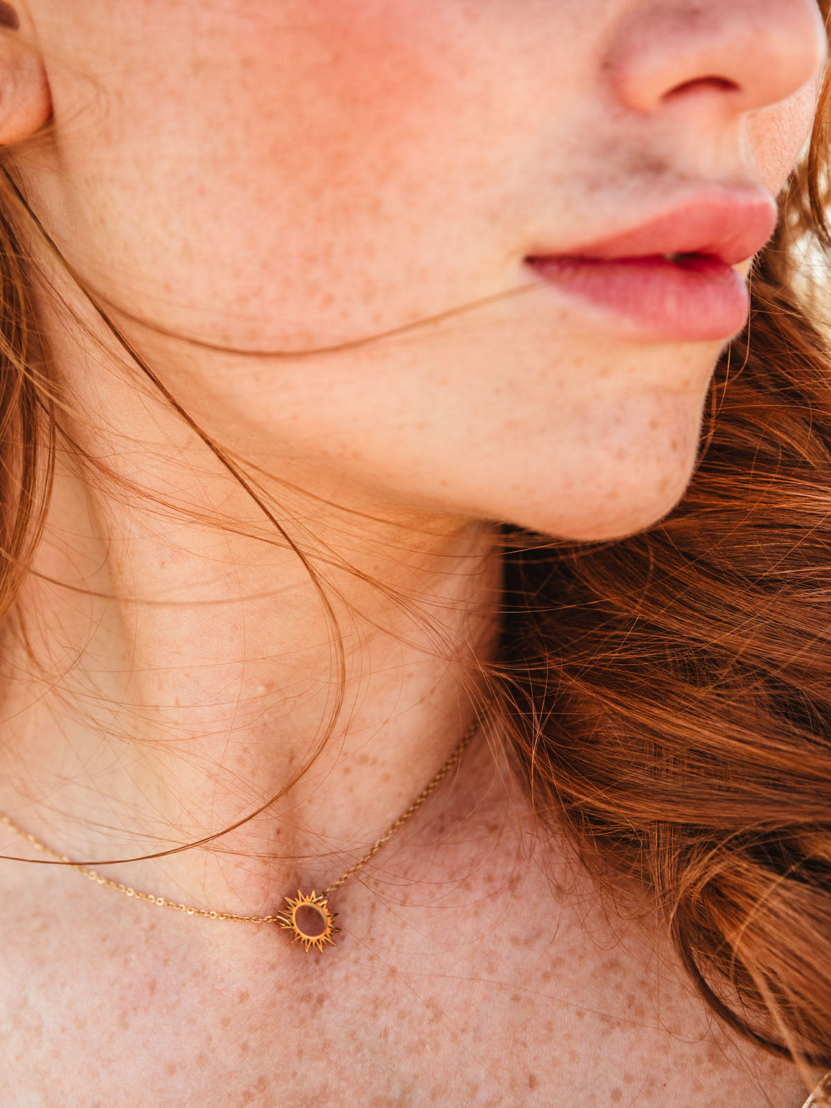 Close up of model wearing the Mallory Sun Chain Pendant
