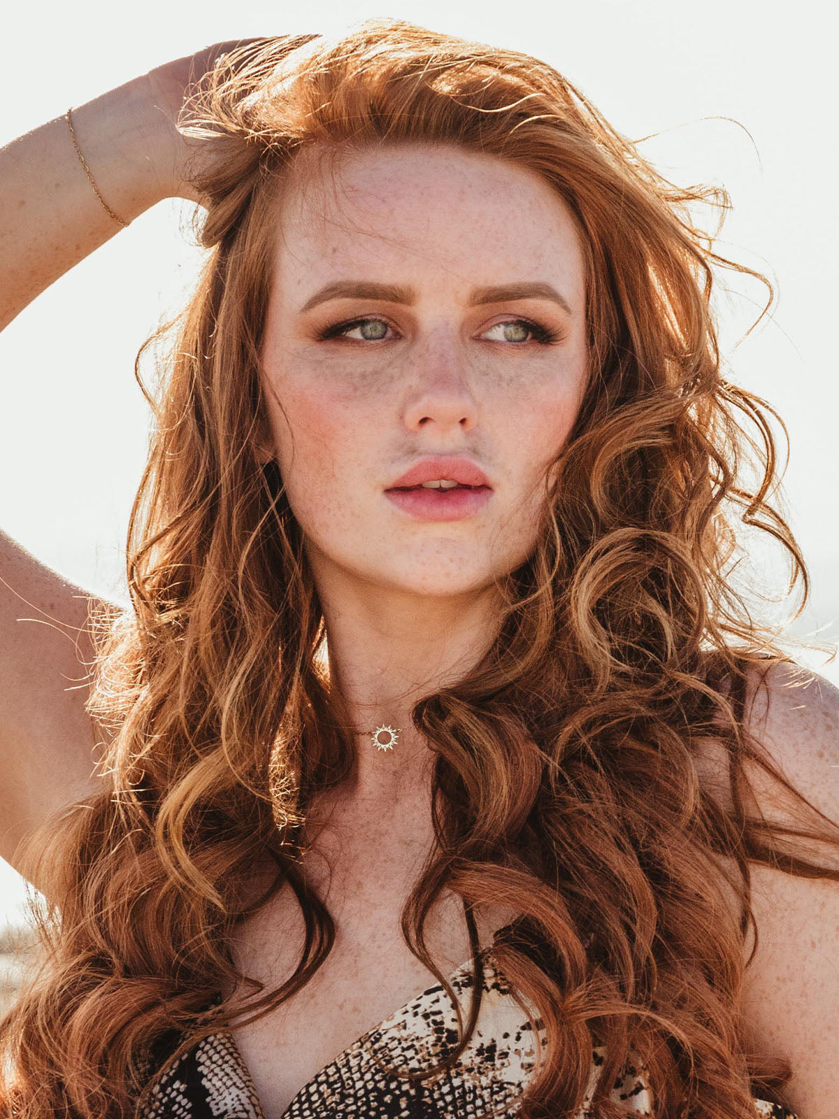 Portrait of female model with red hair wearing the Mallory Sun Chain Pendant necklace.