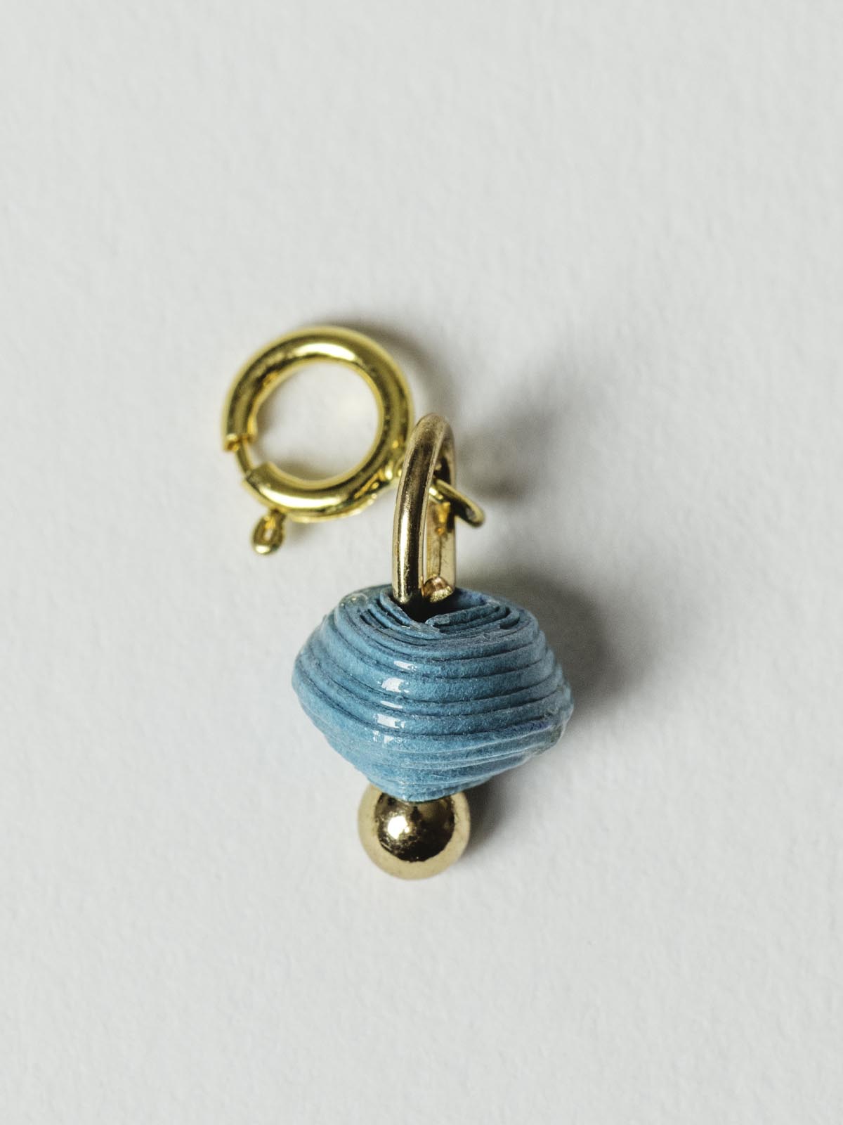 Turquoise blue bead charm on gold clasp. 