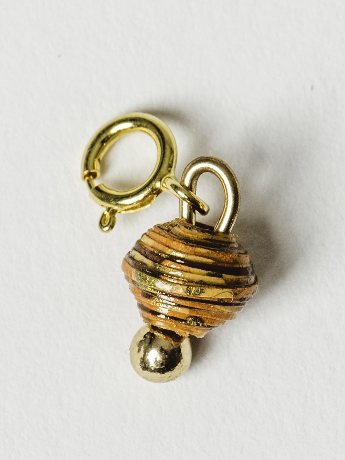Burnt orange bead charm on gold clasp. 