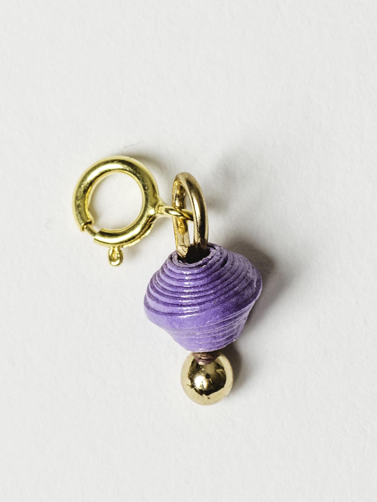 Purple bead charm on gold clasp. 