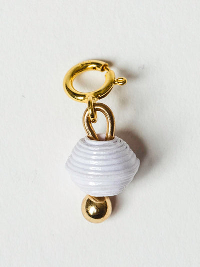 White bead charm on gold clasp. 