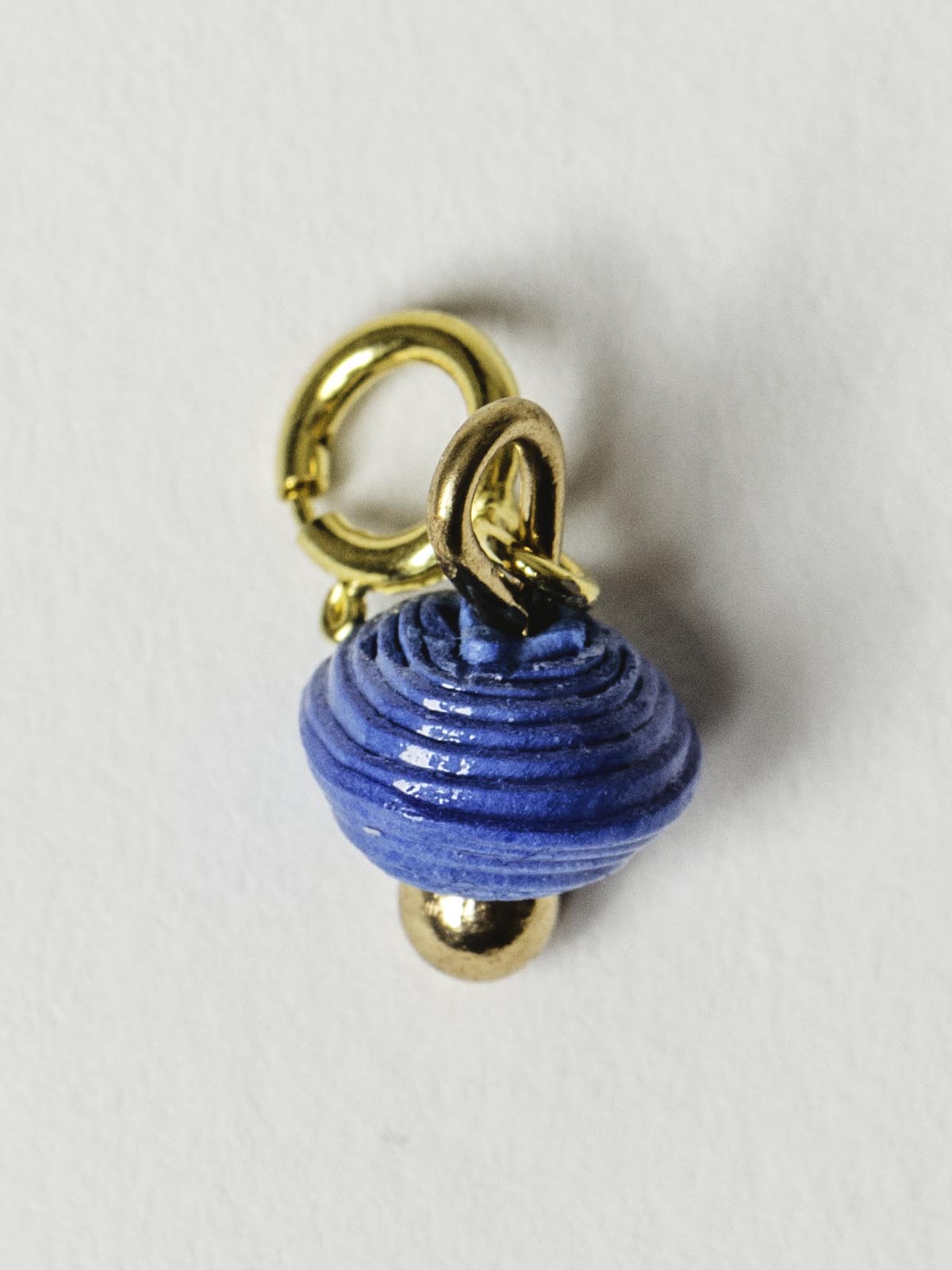True  blue bead charm on gold clasp. 