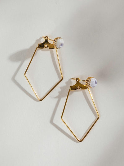 Geometric Gold earrings on white background