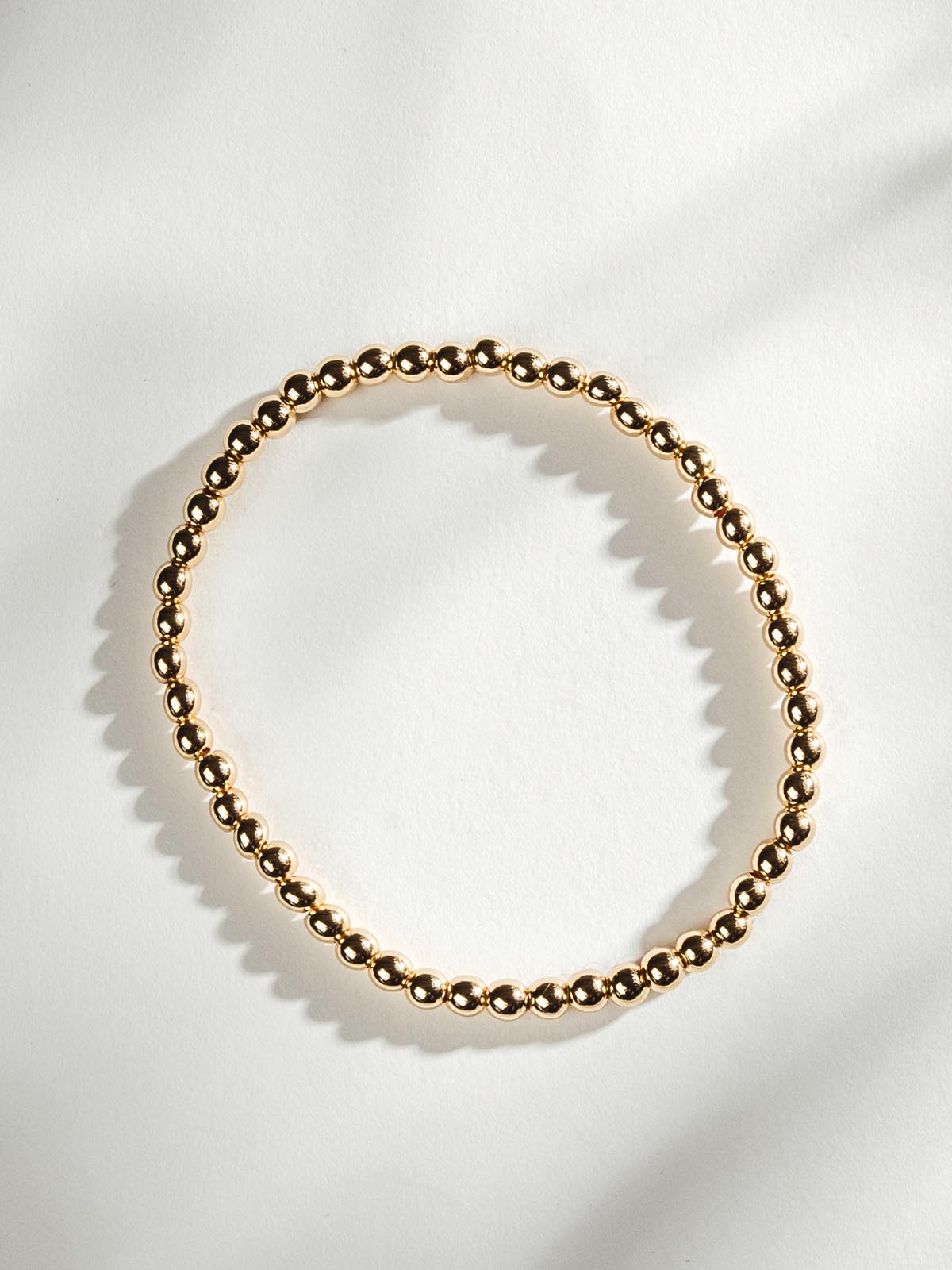 Gold Beaded Bracelet on White Background