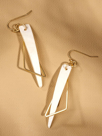 Earrings with white triangular dangle layered with thin gold triangular dangle on a tan background.