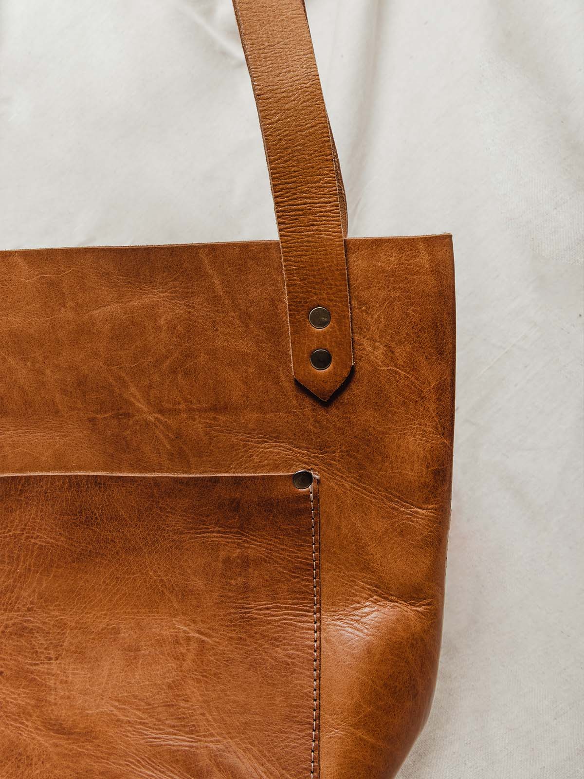 Detail of high quality hazelnut colored leather and front pocket.