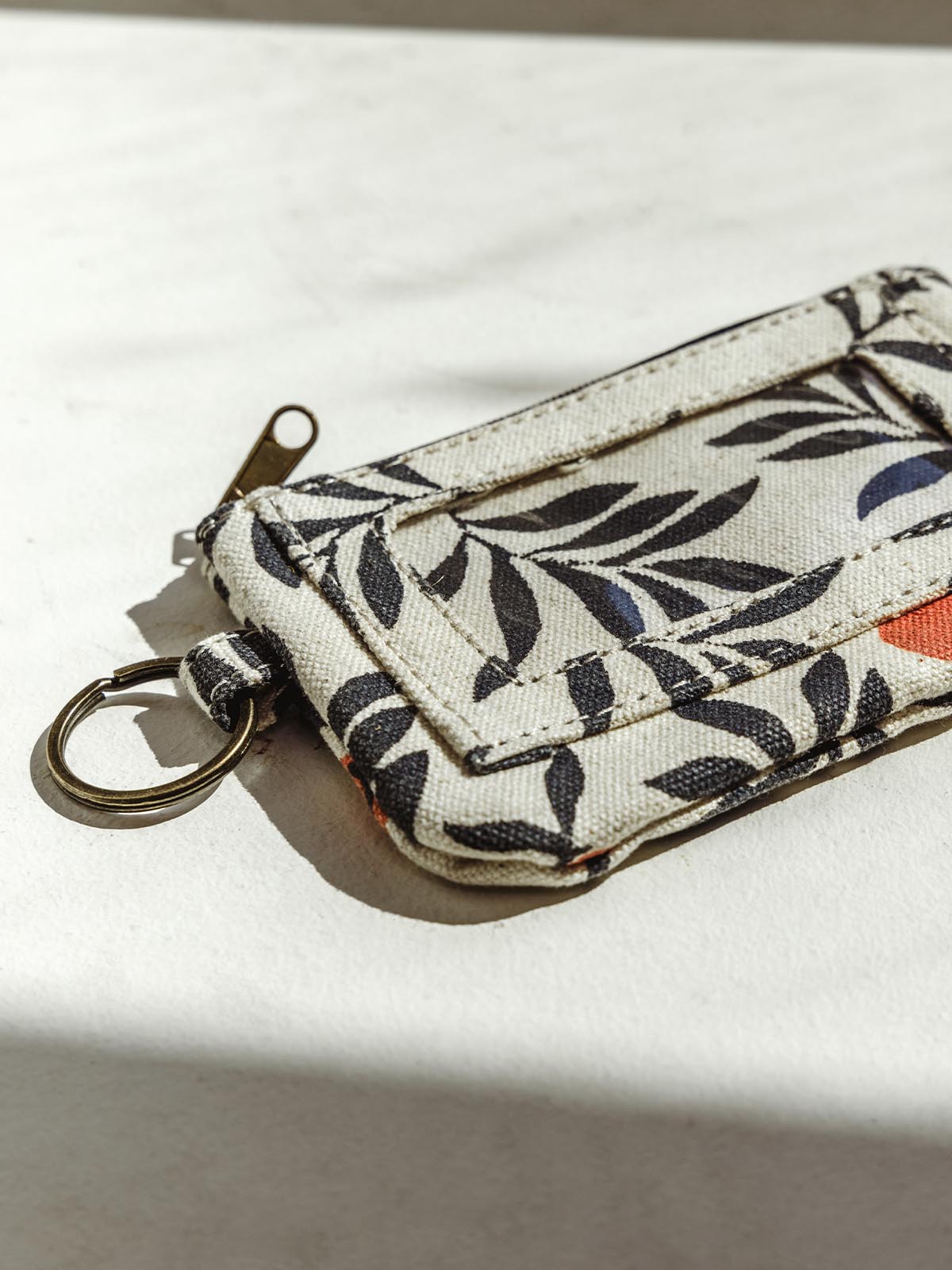 Berry print ID pouch on a white surface
