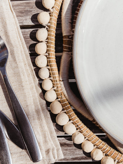 details of charger and quality beading at a table setting