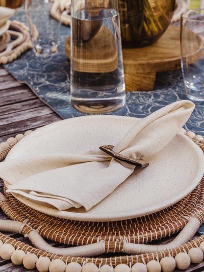 cream cloth napkin at outdoor table setting 