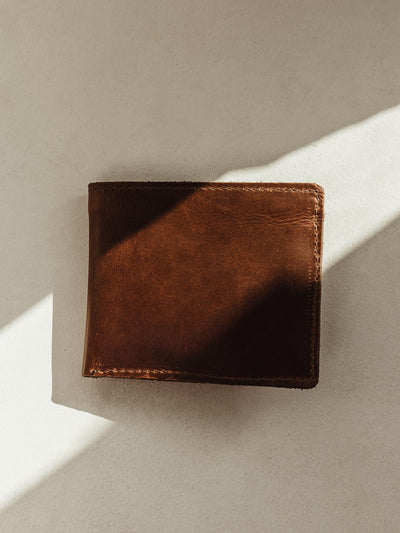 Closed dark brown leather bifold wallet 