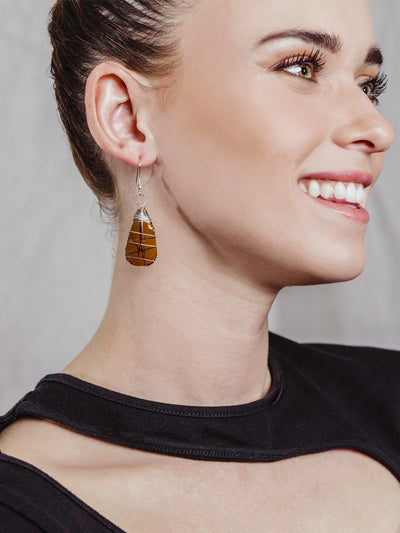 Model wearing amber glass earrings wrapped in silver wire