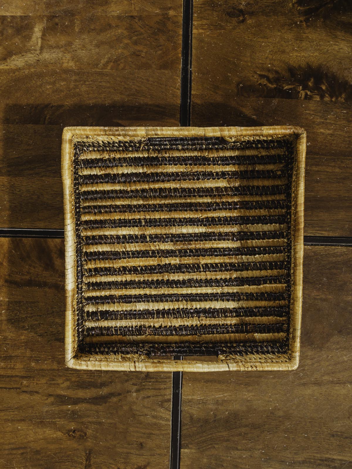 Square woven basket in square shape on brown table