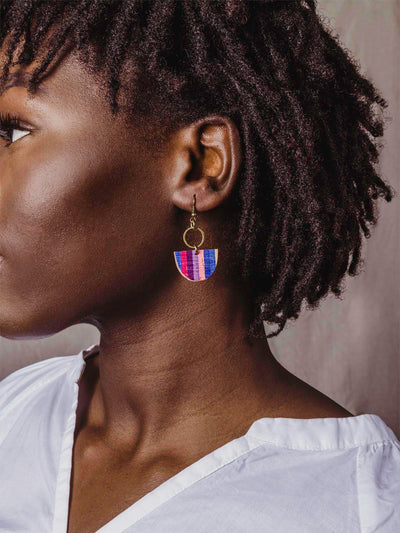 blue, pink, maroon, purple, blue and yellow half circle earrings with gold metal on model wearing white shirt.
