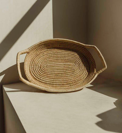 Tan serving tray with shadows from window