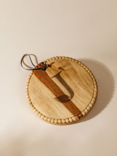 Circular charcuterie board on cream background with large logo customized on board. 