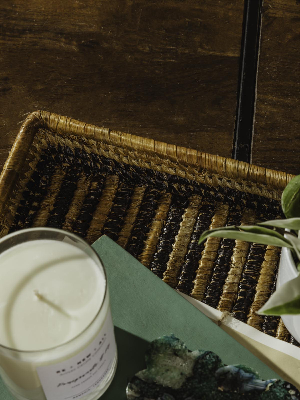 Square woven basket with candle ontop