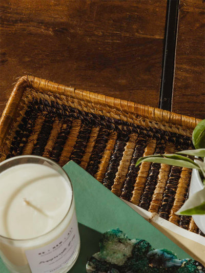 Square woven basket with candle ontop