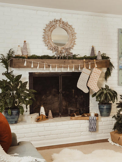 Wooden Mantle with white tassle garland on it