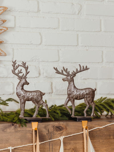 Large handmade metal reindeer on decorated mantle. 