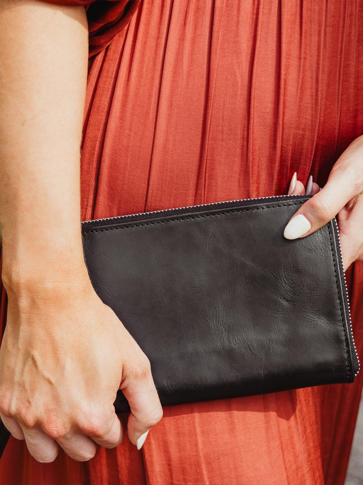 Woman wearing red dress holding the black rani questions