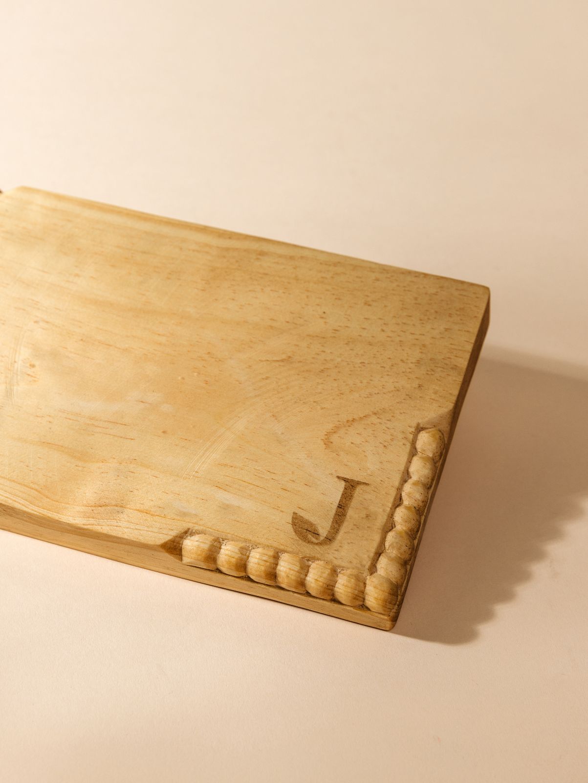 Detail of custom logo on rectangular charcuterie board. 