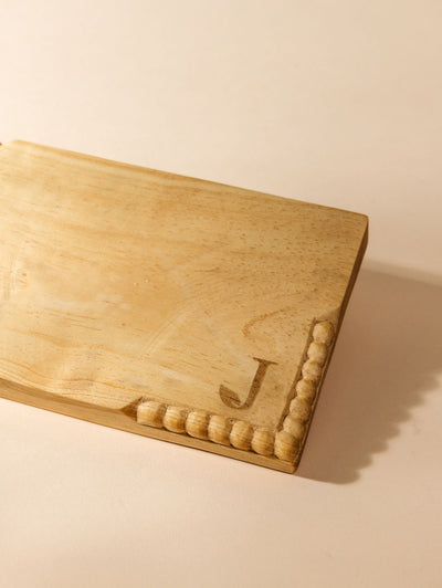 Detail of custom logo on rectangular charcuterie board. 