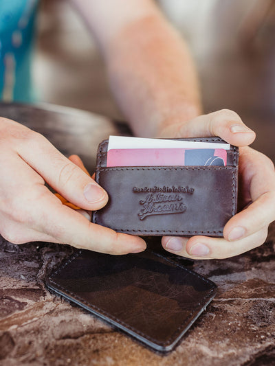 Male hands howling card holder with cards place in card holder.