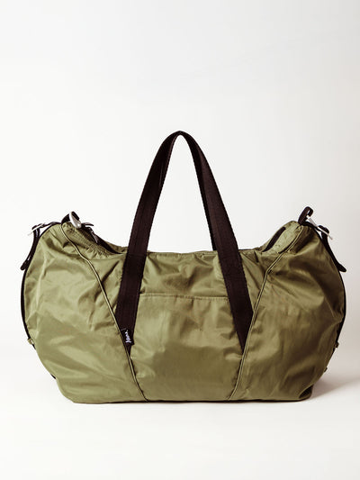 Full view of an olive green duffel bag with dual black straps and a front slip pocket, shown against a white background.