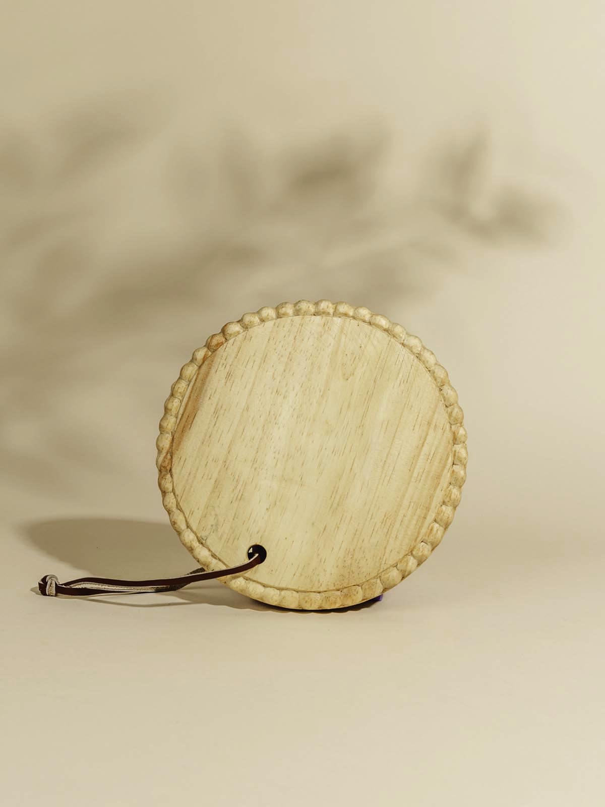 Round wooden serving tray on beige background