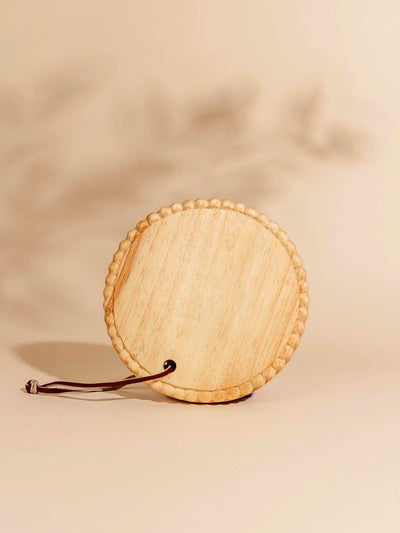 Round wooden serving tray on beige background