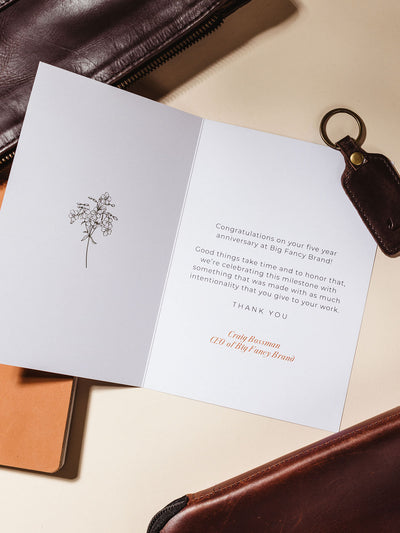 5 years of excellence gifting card example on cream background with congratulations message.