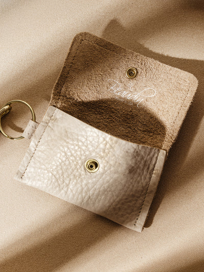 Beaudin beige leather coin pouch with gold snap closure and suede interior, featuring the 'Beaudin Made in USA' logo. A stylish and practical accessory for carrying small essentials.