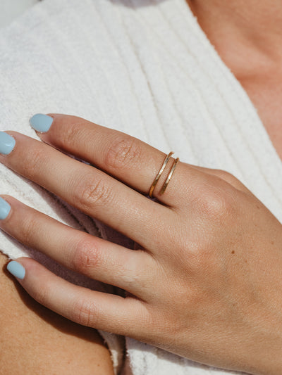 Gold hammered wrap ring on a female hand.