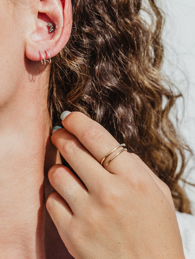 Gold hammered wrap ring on a female hand.