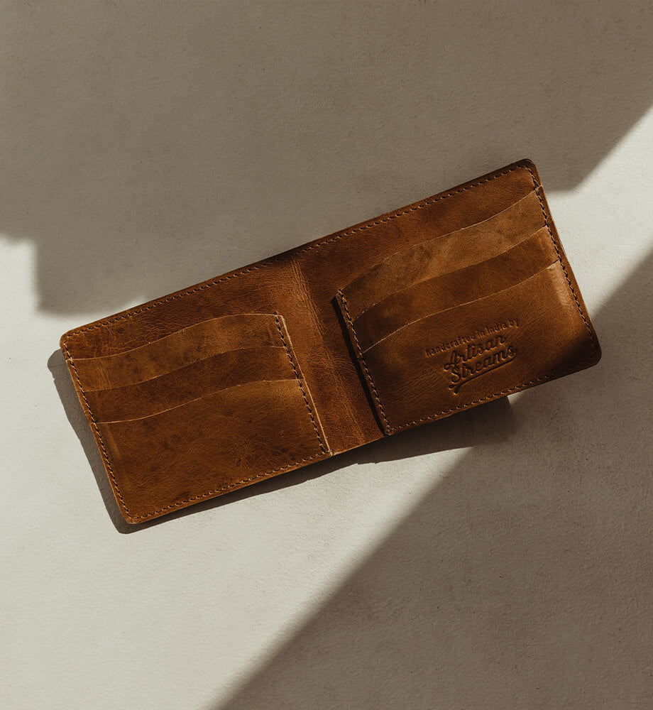 Open leather wallet in front of a white wall