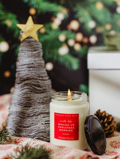 Hand-poured soy candle “Waking Up Christmas Morning” with festive tabletop tree, sustainable holiday home decor gift