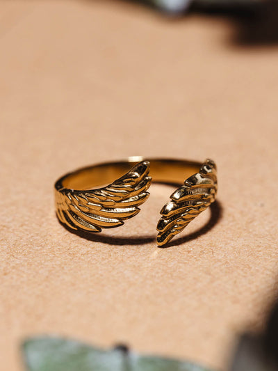 Close up of golden feather/wing ring.