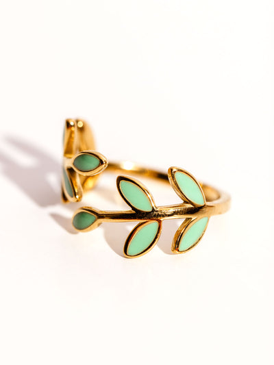 Seeds of Hope Ring on white. Ring feature blue and gold leaves.